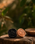 Witoca coffee and cacao soaps with a wooden soap dish on a tree stump