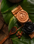 Witoca coffee and cacao soaps on a wooden soap dish with coffee and cacao beans