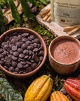Bowl of Ceremonial Cacao Drops and a cup of cacao drink with Palo Santo
