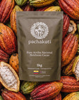 1kg bag of Pachakuti Ceremonial Cacao, 100% pure Arriba Nacional, on fresh cacao pods