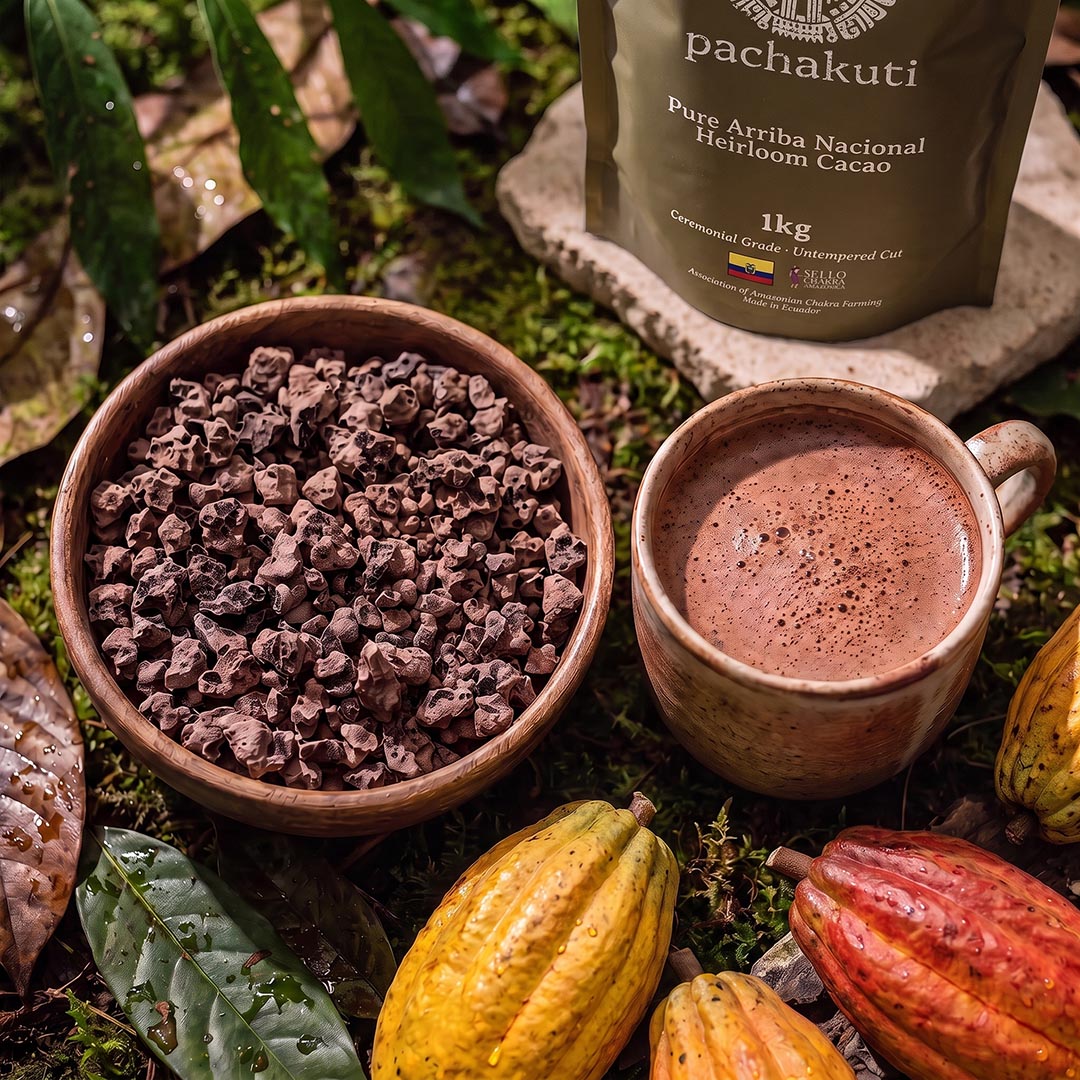 Bowl of Ceremonial Cacao chunks and a cup of cacao drink beside the 1kg bag