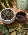 Bowl of loose guayusa leaves and a cup of brewed Guayusa tea