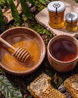HASA honey in a bowl with a honey dipper, a cup of tea and honeycomb