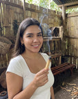 Woman holding a smoking stick of Palo Santo