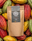 250g bag of Pachakuti unroasted Arriba Nacional cacao beans on fresh cacao pods