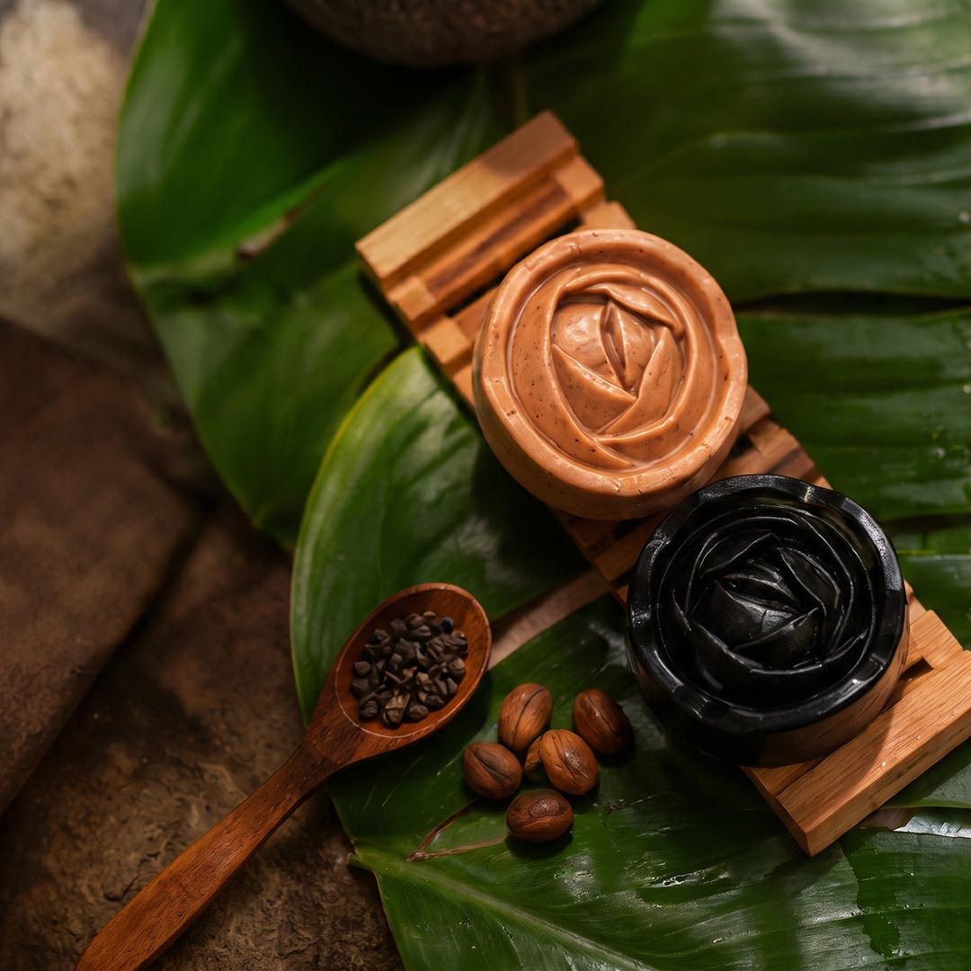 Witoca coffee and cacao soaps on a wooden soap dish with coffee and cacao beans