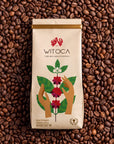 Bag of Witoca Sumak coffee on roasted coffee beans